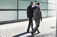 businessmen-walking-embrace.jpg