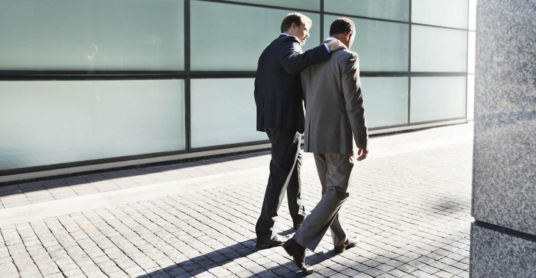 businessmen-walking-embrace.jpg