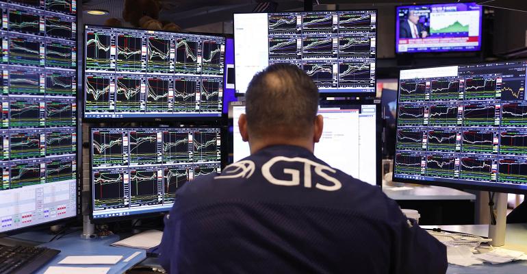 stock trader looking at screens Advisor Sentiment Index February